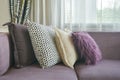 L shape purple sofa with stylish pillows in living room Royalty Free Stock Photo