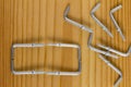 L Shaped Self Tapping Metal Hook on wooden background