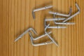 L Shaped Self Tapping Metal Hook on wooden background