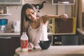 L woman breakfast pours cereal from box into bowl Royalty Free Stock Photo