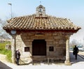 Elderly woman waiting at the entrance to the old church that stand the test of time and modern life Royalty Free Stock Photo