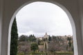 La alhambra palace and generalife gardens viewed through an ancient arc window Royalty Free Stock Photo