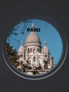 La Basilique Sacre Coeur seen through a circular window labeled Paris Royalty Free Stock Photo