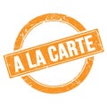 A LA CARTE text on orange grungy round stamp