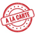A LA CARTE text on red grungy round rubber stamp