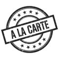 A LA CARTE text written on black vintage round stamp