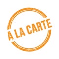 A LA CARTE text written on orange grungy round stamp