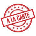 A LA CARTE text written on red vintage round stamp