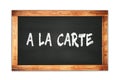 A LA CARTE text written on wooden frame school blackboard