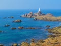 La Corbiere Lighthouse on the rocky coast of Jersey Island Royalty Free Stock Photo