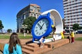 Woman looking at the time in a giant clock with children. Public park close to Riazor Beach. La Coruna, Spain, 22 Sep 2018.