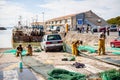 Fishermen are mending nets on the dock of the fishing port of La CotiniÃÂ¨re on the Oleron Island, France Royalty Free Stock Photo