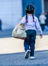 La defense, France - April 9, 2014: Rear view of child walking on city road