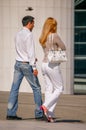 La defense, France - August 30, 2006: Stylish couple walking in a street. The man is wearing blue jean's and the woman white pant