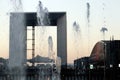 Paris business district La defense Grande arche water jet at winter sunset france.