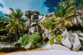 La Digue island, Seychelles. Grand Anse bizarrely shaped granite boulders with palm trees on the beach