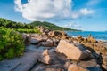 La Digue, Seychelles. Beautiful secluded beach. Tropical ocean coast, unique granite rocks and lonely sail boat in sea Royalty Free Stock Photo