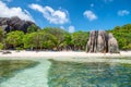 LA DIGUE, SEYCHELLES - SEPTEMBER 11, 2017: Tourists relax on the beautiful Source Argent Beach on a sunny day