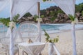 La Digue, Seychelles. Wedding arch gazebo ceremonial decorated with white flowers on a tropical grand anse sand beach