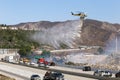 LA Fire Department helicopter dropping fire retardant near freeway Royalty Free Stock Photo