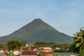 LA FORTUNA, COSTA RICA - MAY 8, 2016: Volcano Arenal soaring behind La Fortuna villag