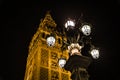 La Giralda in Seville with a lit street lamp at night Royalty Free Stock Photo