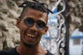 La Havana, Cuba, January 08, 2017: Portrait of a black cuban man with sunglasses on street from la Havana. Afrocaribbean rasta cu