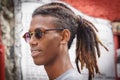 La Havana, Cuba, January 08, 2017: Portrait of a black cuban man with sunglasses on street from la Havana. Afrocaribbean rasta cu