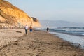 People Walk Along Torrey Pines State Beach Near Sunset