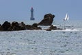 La Jument lighthouse and sailboat