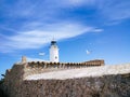 La Mola Lighthouse with blue sky and flying seagulls