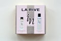 La rive IN woman deodorant and perfume bottles in brand box on beige background. LA RIVE S.A. is one of the leading producers of Royalty Free Stock Photo