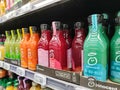 Supermarket shelves filled with many bottles of fresh squeezed fruit juice Innocent Brand