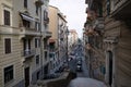 Straight narrow street between old residential buildings in typical Italian style