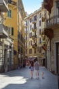 LA SPEZIA, ITALY, JULY 4, 2019: young couple from behind walking through the narrow shopping street in the old town of La Spezia,