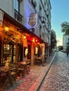 Golden light comes from la Taverne de Montmartre cafe at twilight, Paris, France Royalty Free Stock Photo