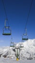 Chairlift at Italian ski area on snow covered Alps during the winter - winter sports concept Royalty Free Stock Photo