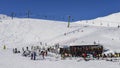 Skiers and snowboarders with their gear relax at a wooden cabin at La Thuile ski resort in Valle d`Aosta, Italy