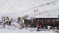 Skiers and snowboarders with their gear relax at a wooden cabin at La Thuile ski resort in Valle d`Aosta, Italy