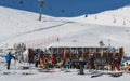 Skiers and snowboarders with their gear relax at a wooden cabin at La Thuile ski resort in Valle d`Aosta, Italy