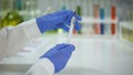 Lab assistant filling syringe with vaccine, antihistamine medication injection