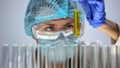 Lab assistant holding test tube yellow liquid, medical worker analyzing urine Royalty Free Stock Photo