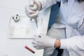 Lab assistant preparing microscope slide for scrutiny