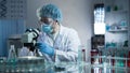 Lab assistant studying samples to detect pathologies, quality medical research Royalty Free Stock Photo