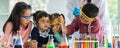 In lab, boy drop something into orange tube