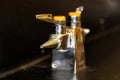 A lab gas valve on a black table and background