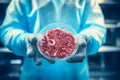 Lab grown meat concept - scientist holds meat in petri dish