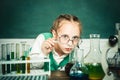 Lab microscope and testing tubes. My chemistry experiment. Back to school and happy time. Cheerful smiling little boy Royalty Free Stock Photo