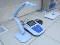 Lab pH conductivity meter and lamp set on laboratory worktable