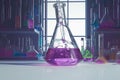 Lab scene features intricate chemical instruments and vibrant reagents